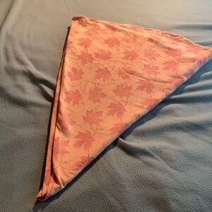 Two-tone orange cotton tablecloth with maples leaf design.  Approximately 58”